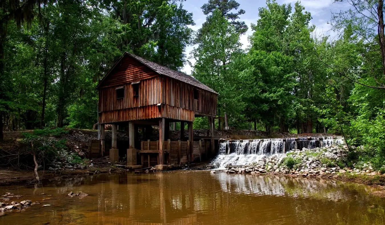 Un antiguo edificio de madera junto a un río en el sur de Estados Unidos