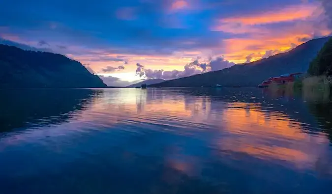 Un coucher de soleil coloré sur la baie de Puyuhuapi avec des montagnes et des collines au loin