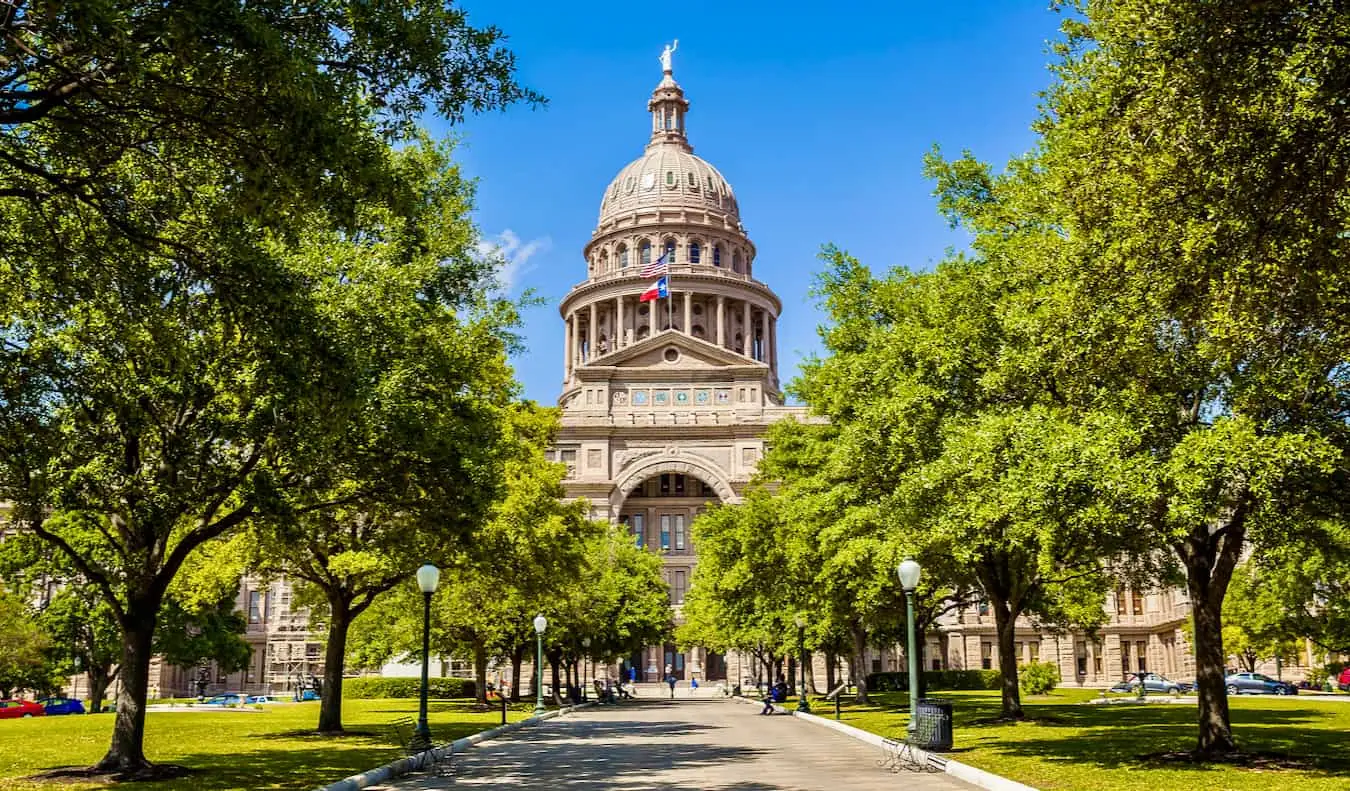 Het State Capitol-gebouw omgeven door bomen en groen in Austin, Texas