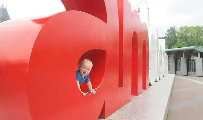 bayi lelaki bergambar di papan tanda iamsterdam di Amsterdam, Belanda di Eropah