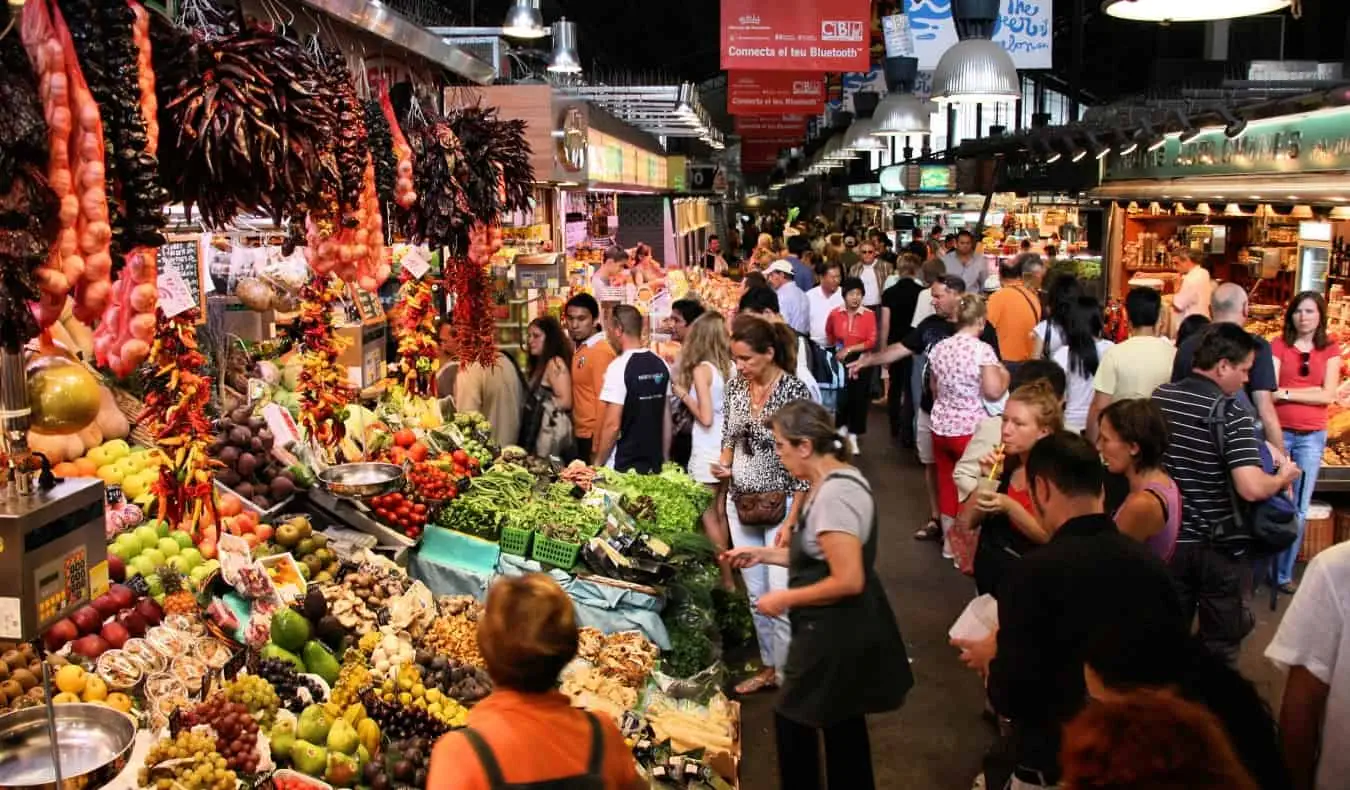 המוני אנשים מסתובבים בשוק בוקריה ההומה בברצלונה, ספרד