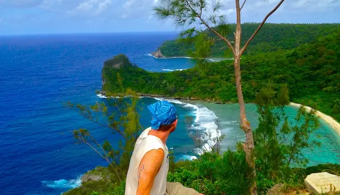 Michael mirando la hermosa playa rodeada de una exuberante jungla.