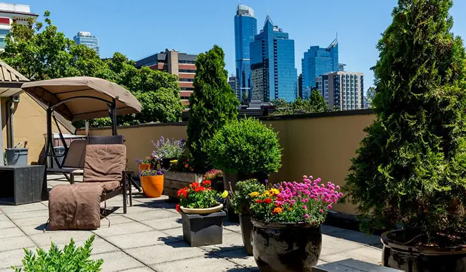 Terraço na cobertura com espreguiçadeiras e arranha-céus ao fundo no HI Vancouver Downtown, Vancouver