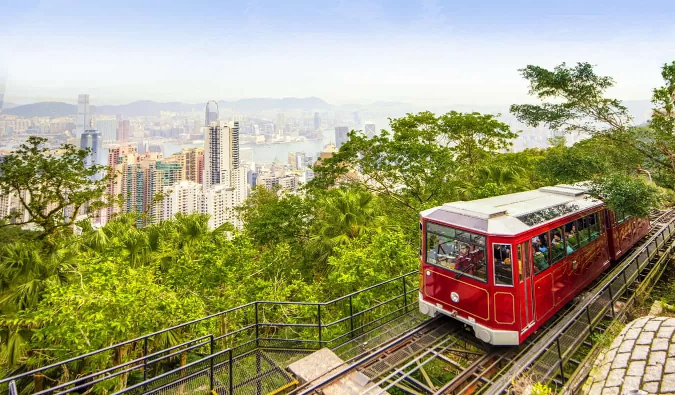 Raudonas Peak Tram su Honkongo dangoraižiais fone