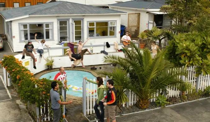 Albergue bungalow con gente saltando a una piscina en Nueva Zelanda