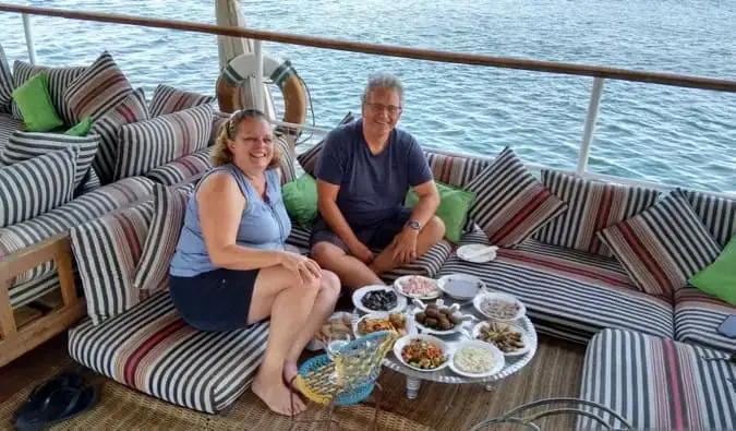 Esther en haar man poseren voor een foto terwijl ze op een boot zijn