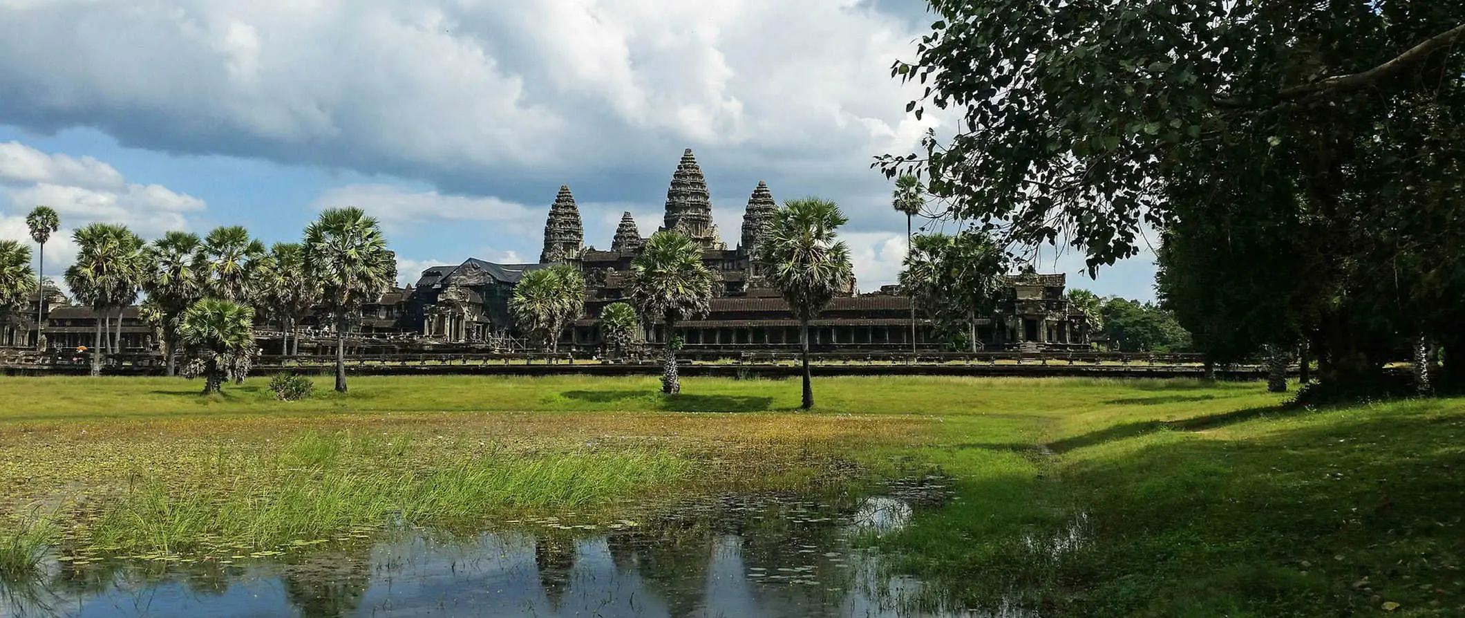 Historiallinen Angkor Watin temppelikompleksi Kambodžassa heijastuu tyynistä vesistä