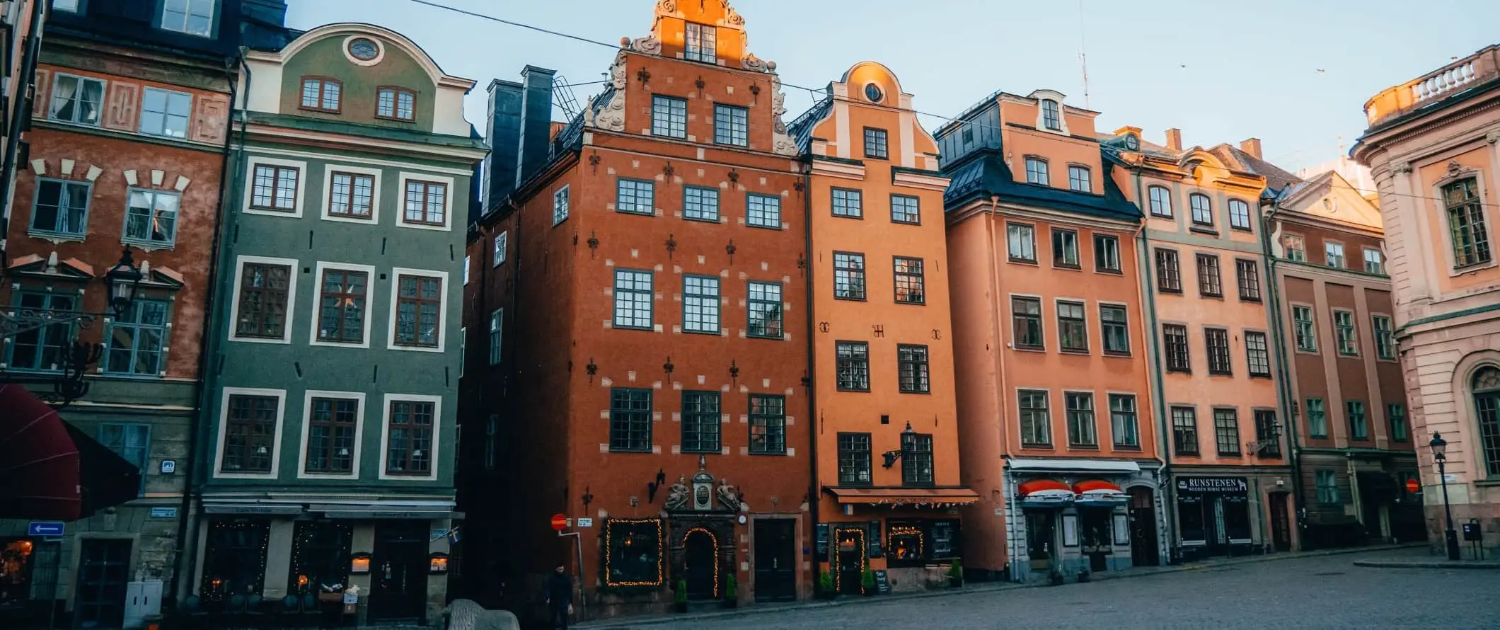 Krāsainas vēsturiskas ēkas, kas ieskauj laukumu Gamla Stan, Stokholmas vecpilsētā, Zviedrijā