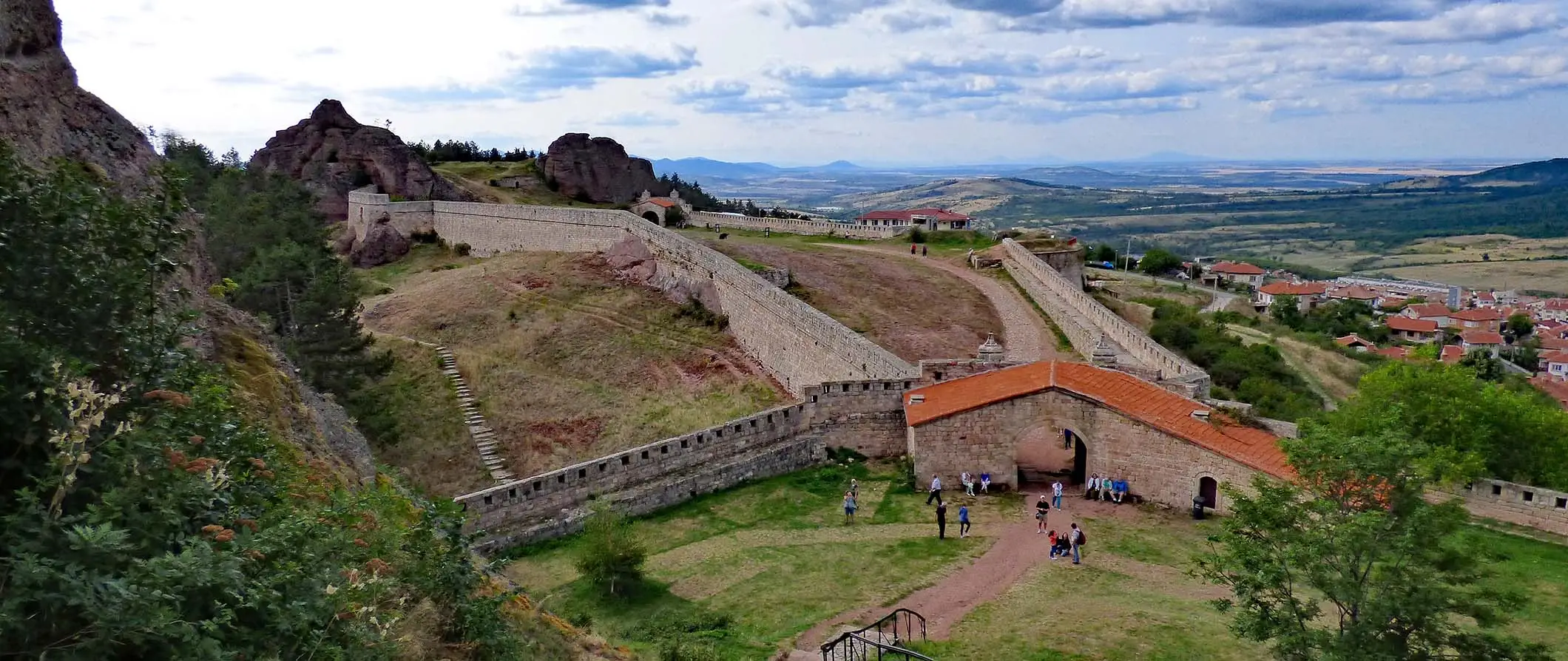 Històrica fortalesa emmurallada envoltada d'un extens paisatge de turons ondulants a Bulgària