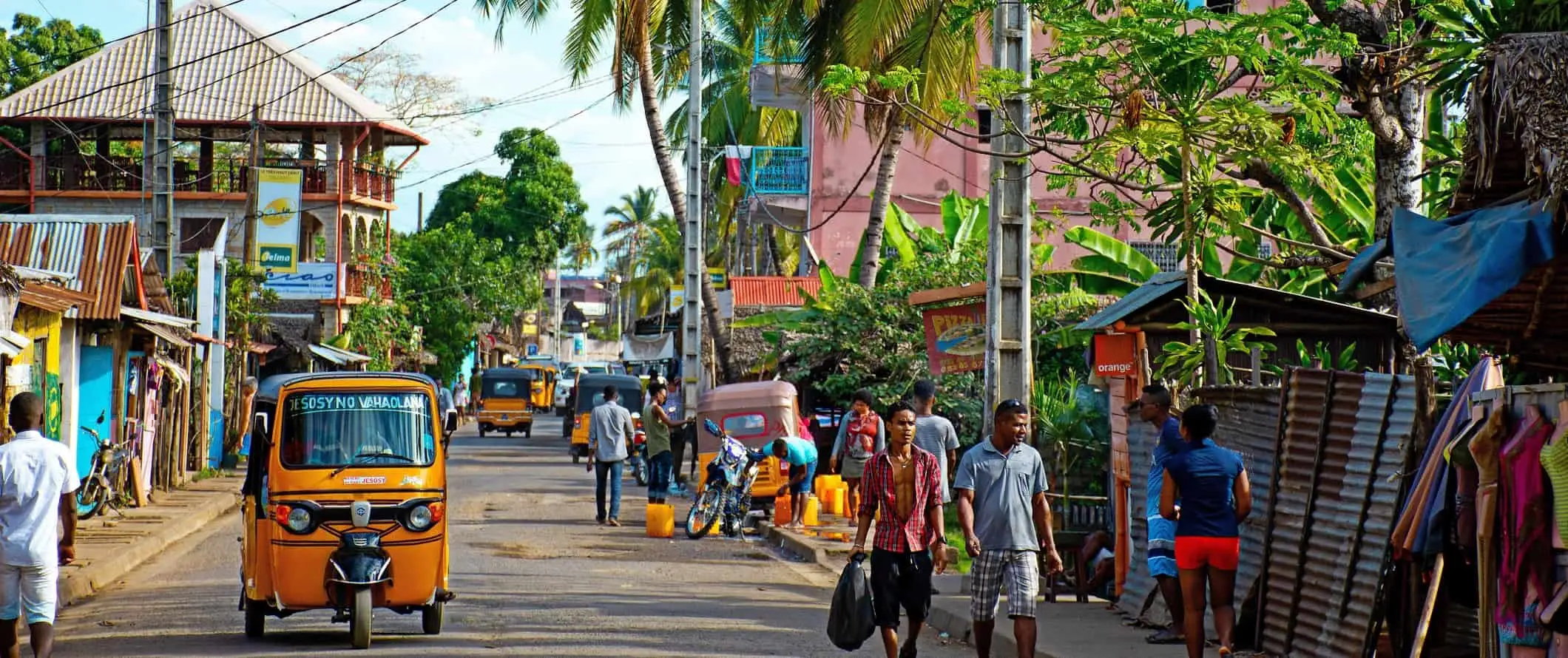 Gent caminant per un carrer concorregut d'una petita ciutat de Madagascar, Àfrica